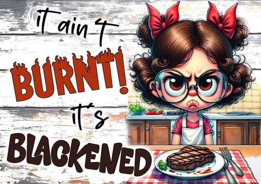 Cartoon character with glasses and bows in hair, standing in a kitchen with text 'it ain't burnt! it's blackened' above a steak on a plate.