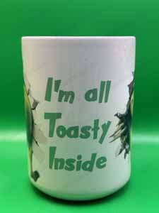 White ceramic mug with green text reading 'I'm all Toasty Inside' on a bright green background.