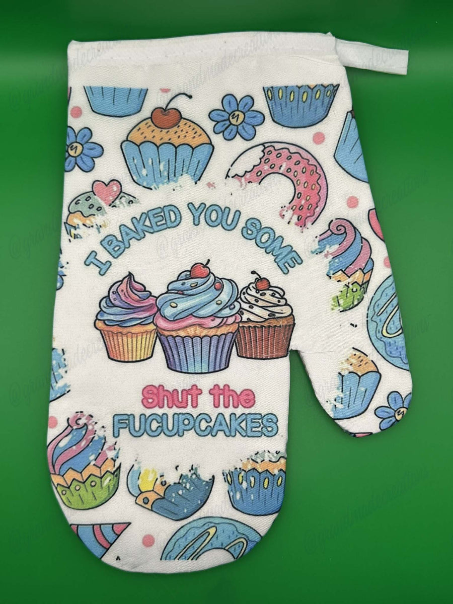 Oven mitt with colorful cupcake design and text