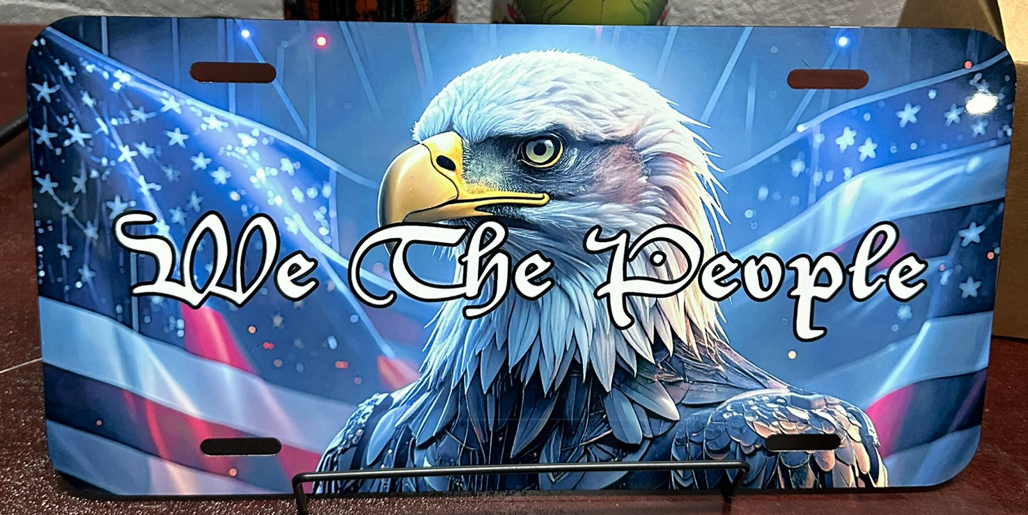 License plate with an eagle and 'We The People' text on a patriotic background